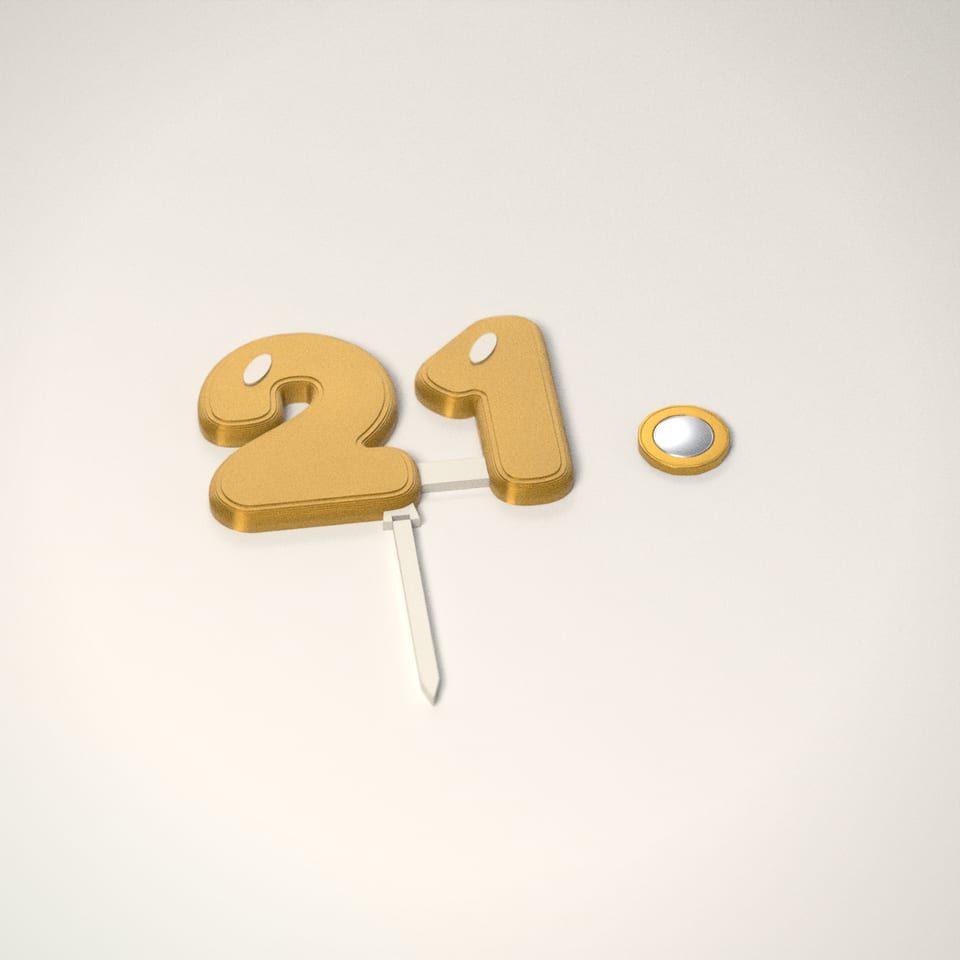 Personalised Age Balloon Cake Topper next to a £1-coin-sized disc for scale