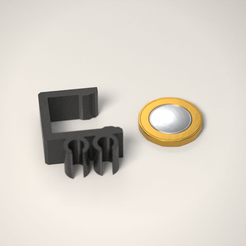 Desk-Edge Cable Clips next to a £1-coin-sized disc for scale