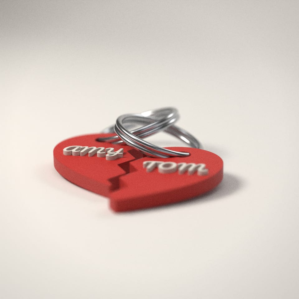 Couples Heart Keyrings (Set of 2) from a low side angle, showing how far the lettering stands up