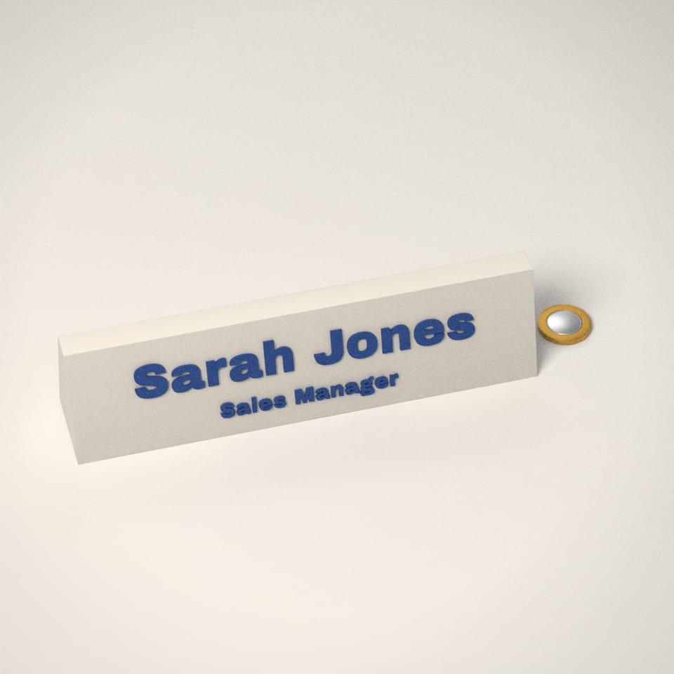 Personalised Desk Name Plate next to a £1-coin-sized disc for scale