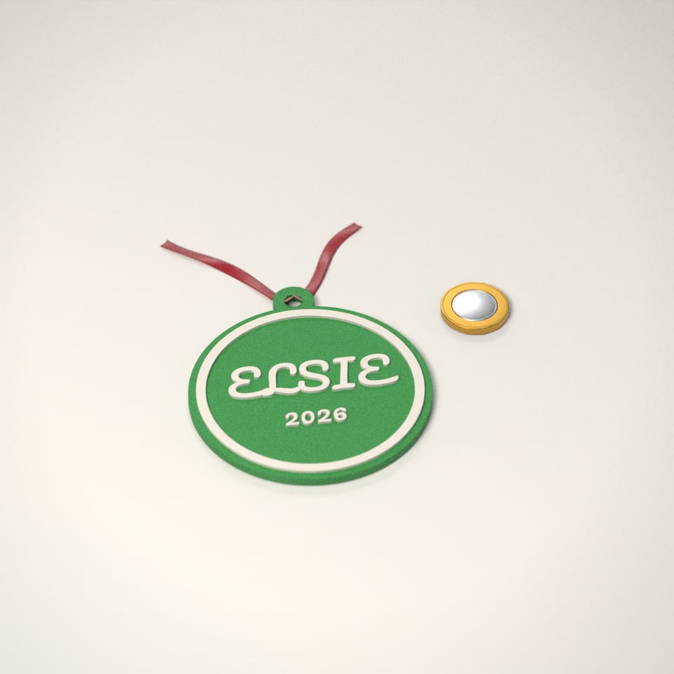 Personalised Name Christmas Bauble next to a £1-coin-sized disc for scale