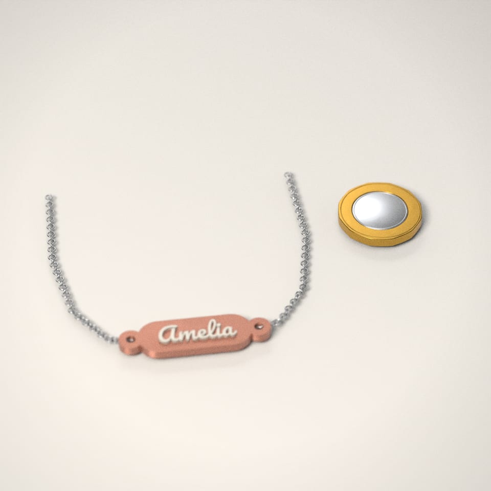Personalised Name Necklace next to a £1-coin-sized disc for scale