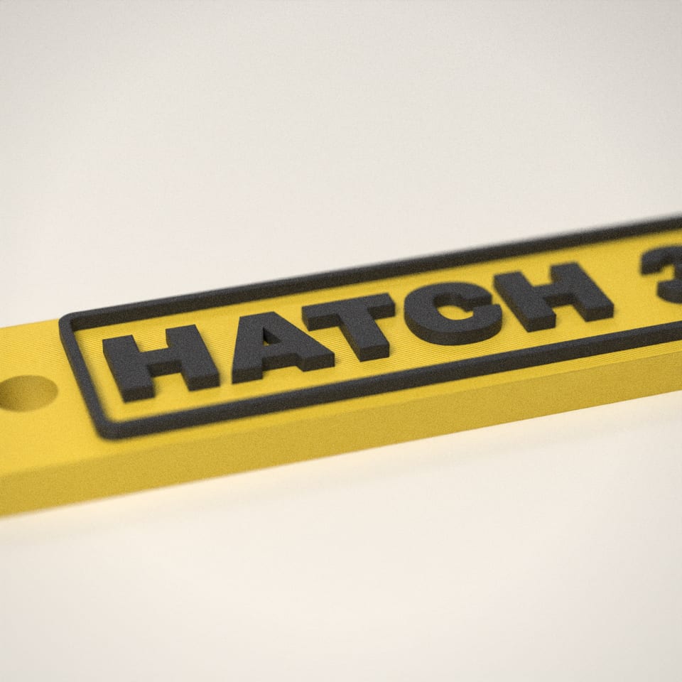 Close-up of the 'HATCH 3D' lettering, showing the fine 0.2 mm print layers