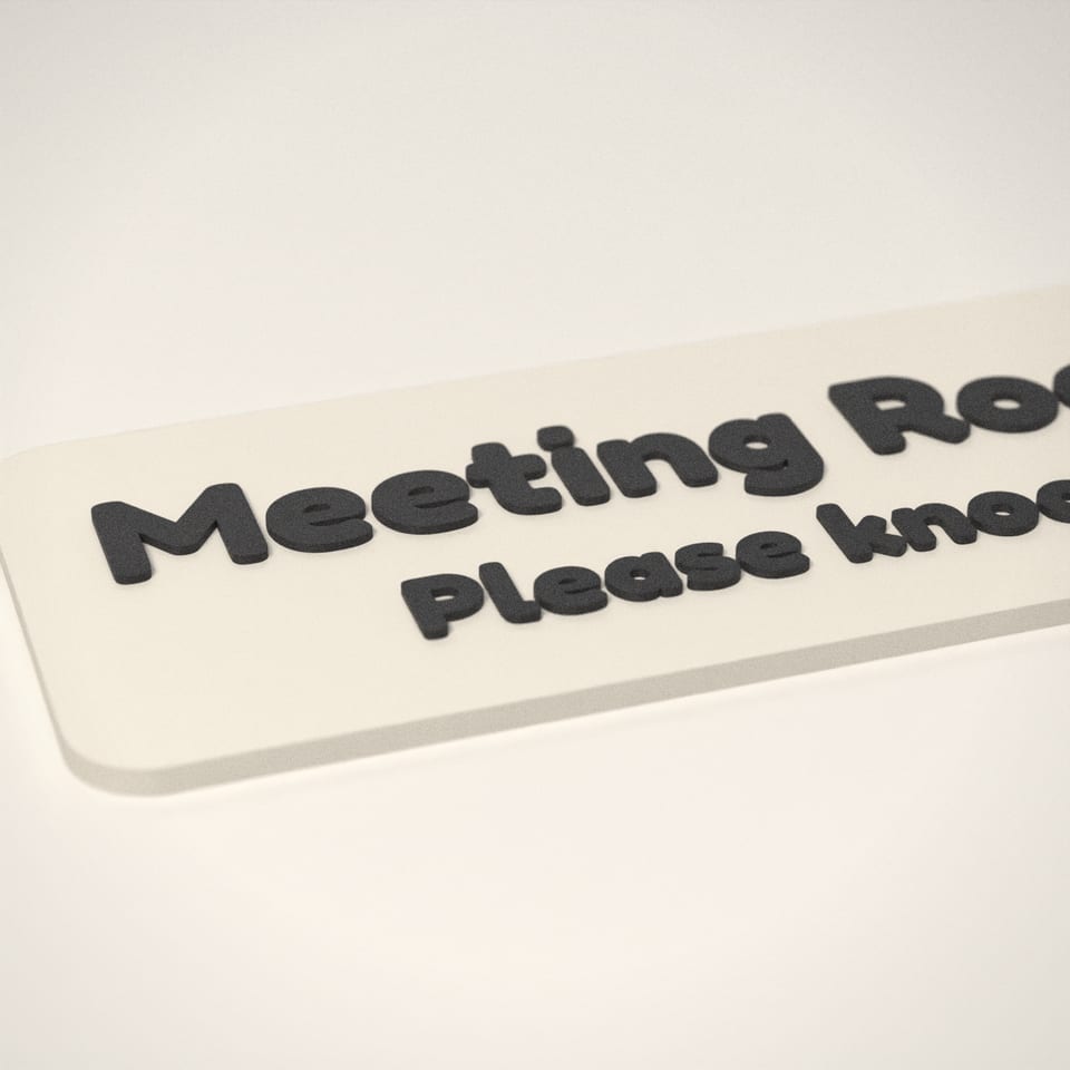Close-up of the 'Meeting Room' lettering, showing the fine 0.2 mm print layers