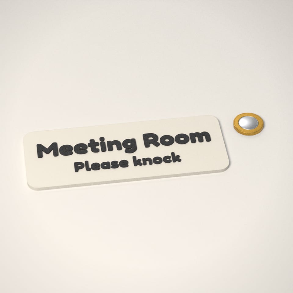 Personalised Door Sign next to a £1-coin-sized disc for scale