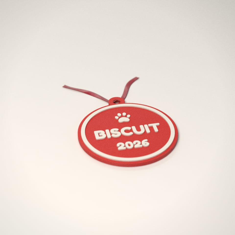 Scarlet Red personalised Pet Christmas Bauble reading 'BISCUIT' in Ivory White letters