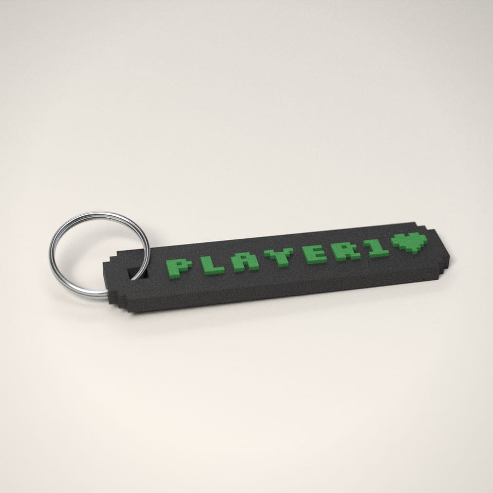 Charcoal Pixel Name Keyring reading 'PLAYER1' in Grass Green letters
