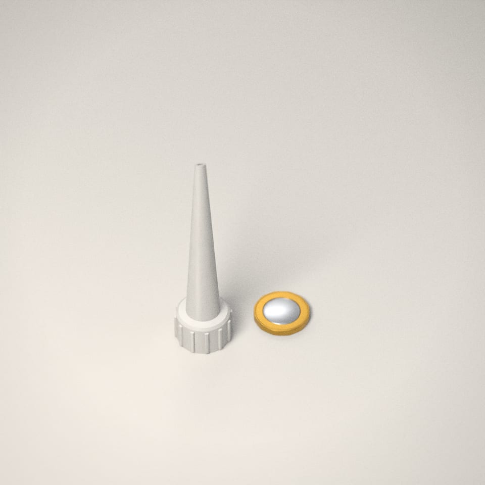 Sealant & Silicone Nozzles next to a £1-coin-sized disc for scale